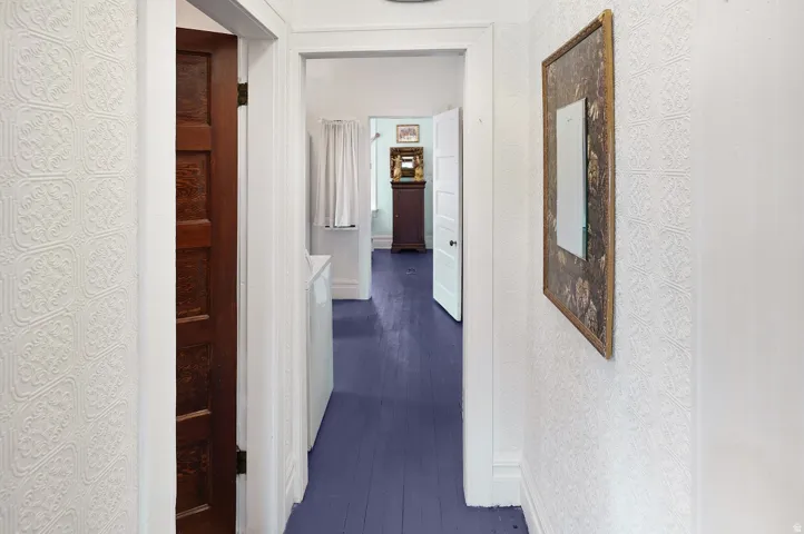 Hallway to bathroom and second bedroom beyond