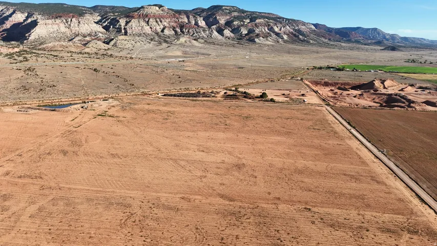 Expansive land parcel featuring open fields and distant mountain ranges