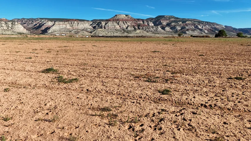 Expansive undeveloped terrain with distant mountainous scenery