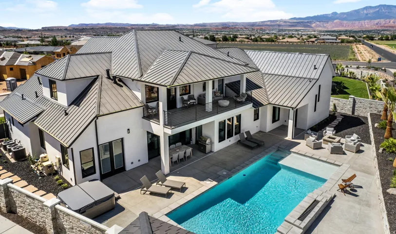 Modern exterior with a light-colored stucco finish and dark-framed windows
