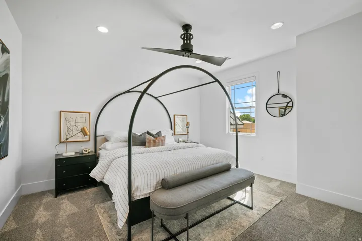 Recessed lighting, ceiling fan, window with white trim, and carpeted flooring