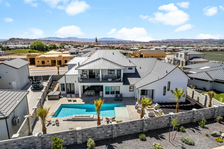 White stucco exterior with a dark metal roof