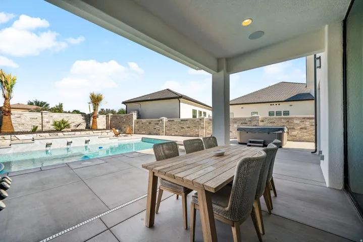 Covered patio with recessed lighting, integrated outdoor speakers, and concrete flooring