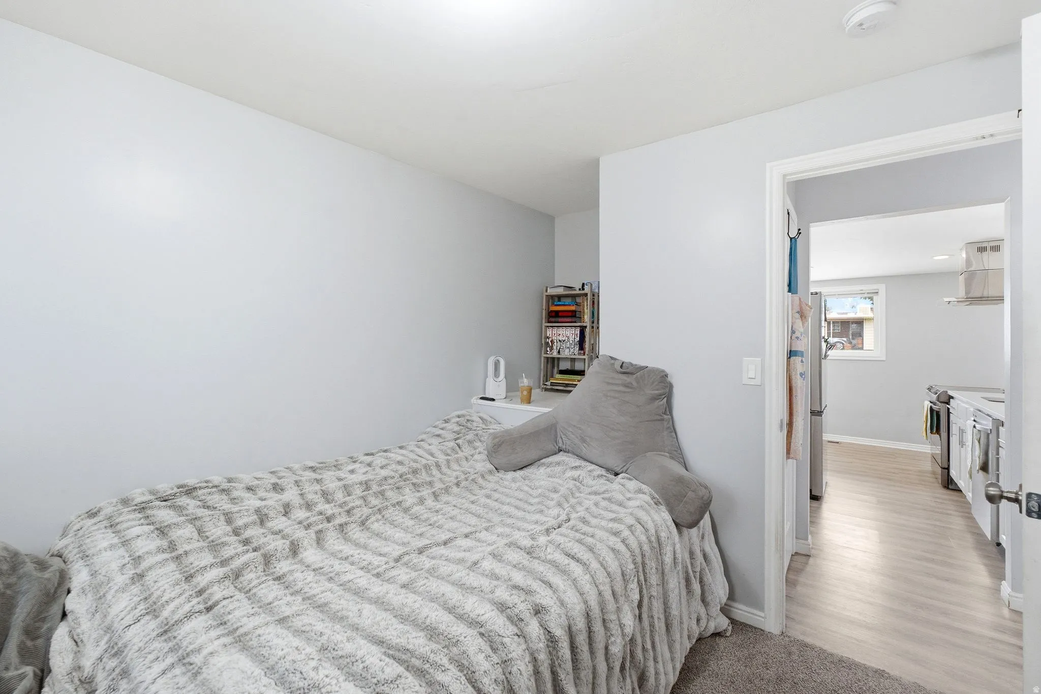 Neutral wall paint, overhead lighting, and wood-finish flooring