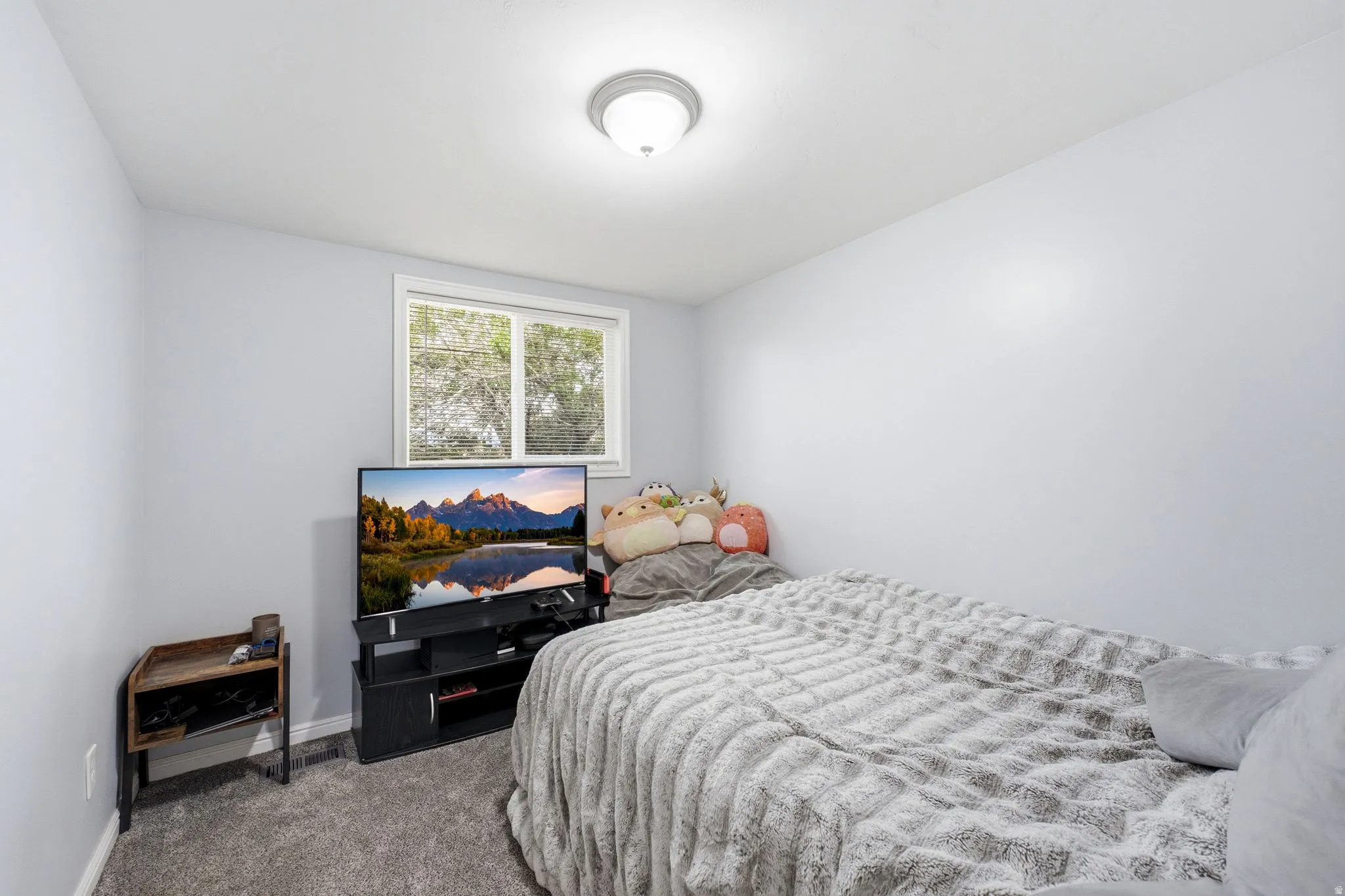 Recessed window with white trim, wall-mounted ceiling light fixture, and light-toned wall paint