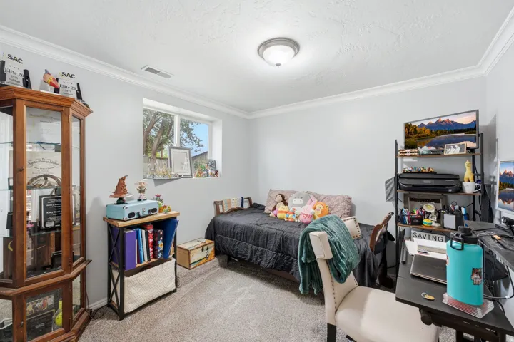 Recessed window with exterior views, crown molding, and a flush mount ceiling light