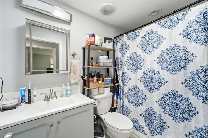 Modern vanity with integrated sink, brushed nickel faucet, and a framed mirror
