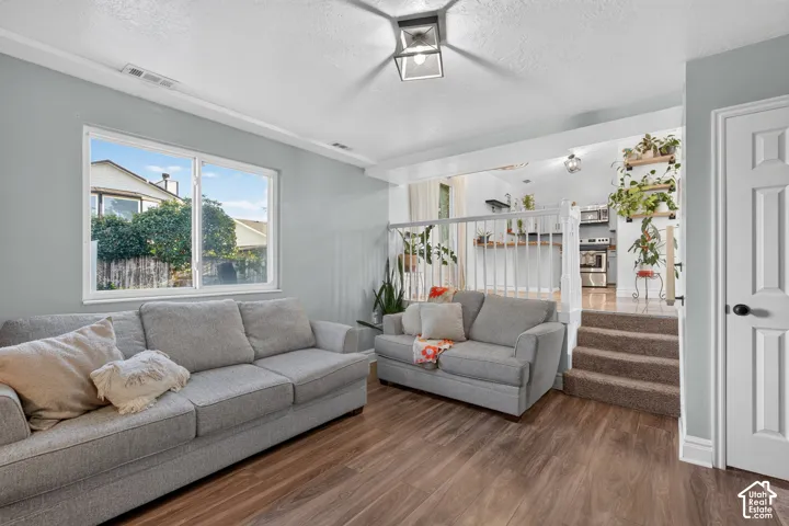 Wood-finish flooring, white trim work, and a multi-level layout define this space