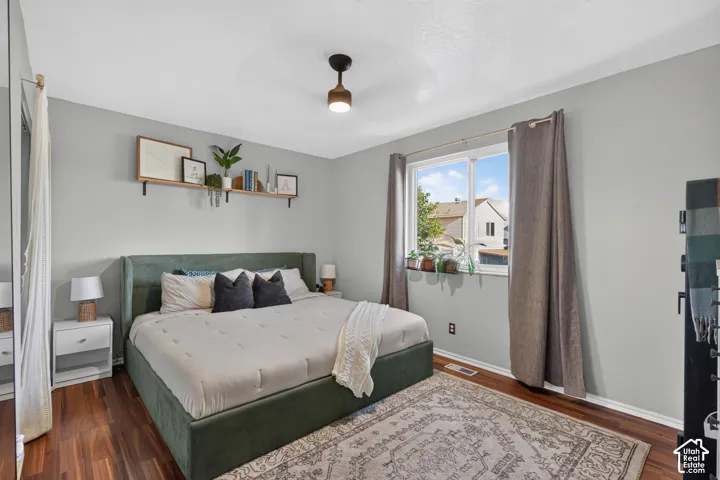 Wood-finish flooring, neutral wall tones, and a window with a sill