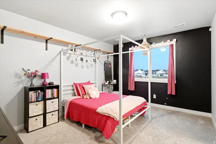 Wall-to-wall carpeting with light-toned walls and an accent wall