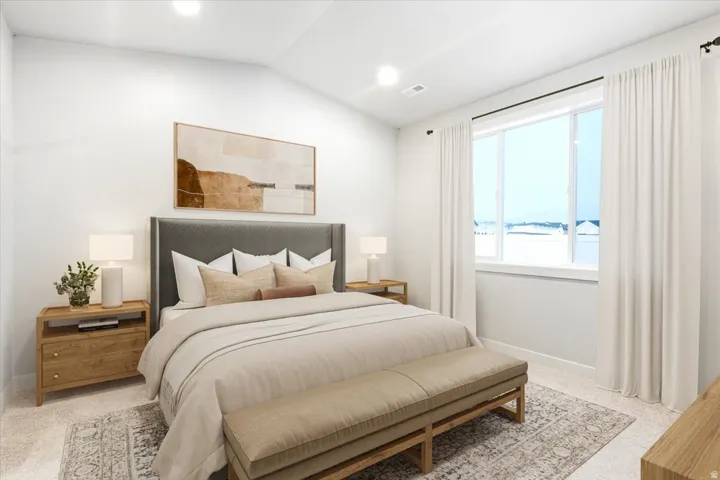Vaulted ceiling, recessed lighting, expansive window with white trim, light-toned wall paint, and plush carpeting