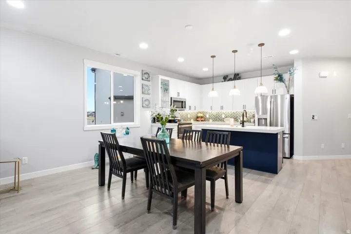 Open-concept living space with light-tone wood-finish flooring