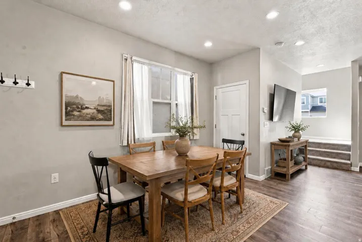 Wood-finish flooring throughout, recessed lighting, and a window with white trim