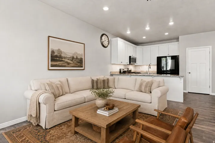 Contemporary kitchen with white cabinetry, stainless steel appliances, granite countertops, and recessed lighting