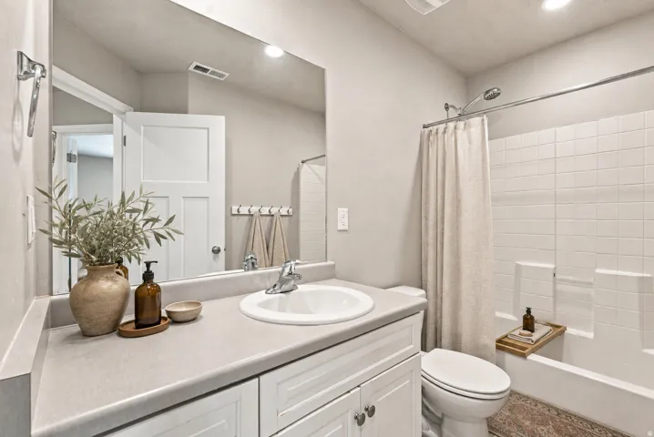White shaker vanity with a built-in sink and light gray countertop