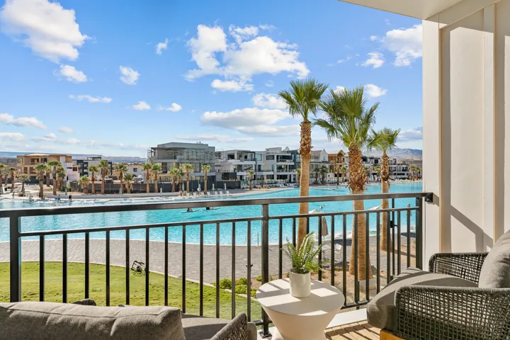Balcony with metal railings, a water feature, and palm trees