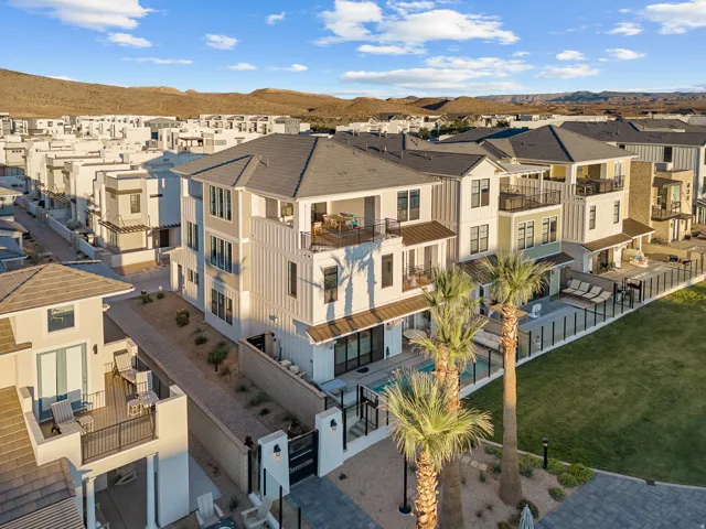 Multi-story exterior with multiple balconies, a private pool, and a fenced patio area