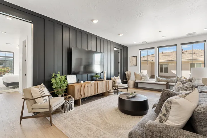 Accent wall featuring vertical paneling, recessed lighting, and wood-finish flooring