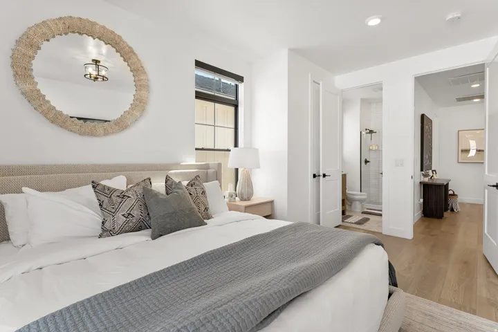 Hardwood flooring throughout, with crisp white walls and black window frames