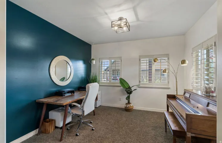 White interior walls with an accent wall and carpet flooring