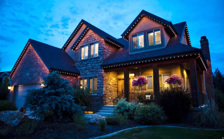 Stone and brick exterior with multiple gables, covered front porch, and integrated two-car garage