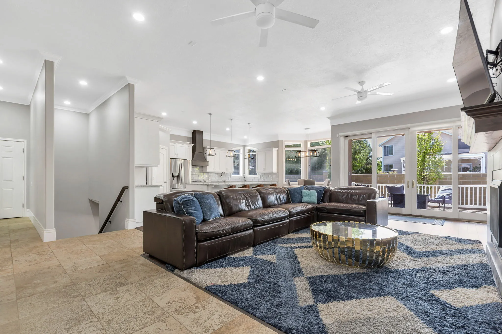 Recessed lighting throughout, two ceiling fans, tile flooring, and sliding glass doors to outdoor area