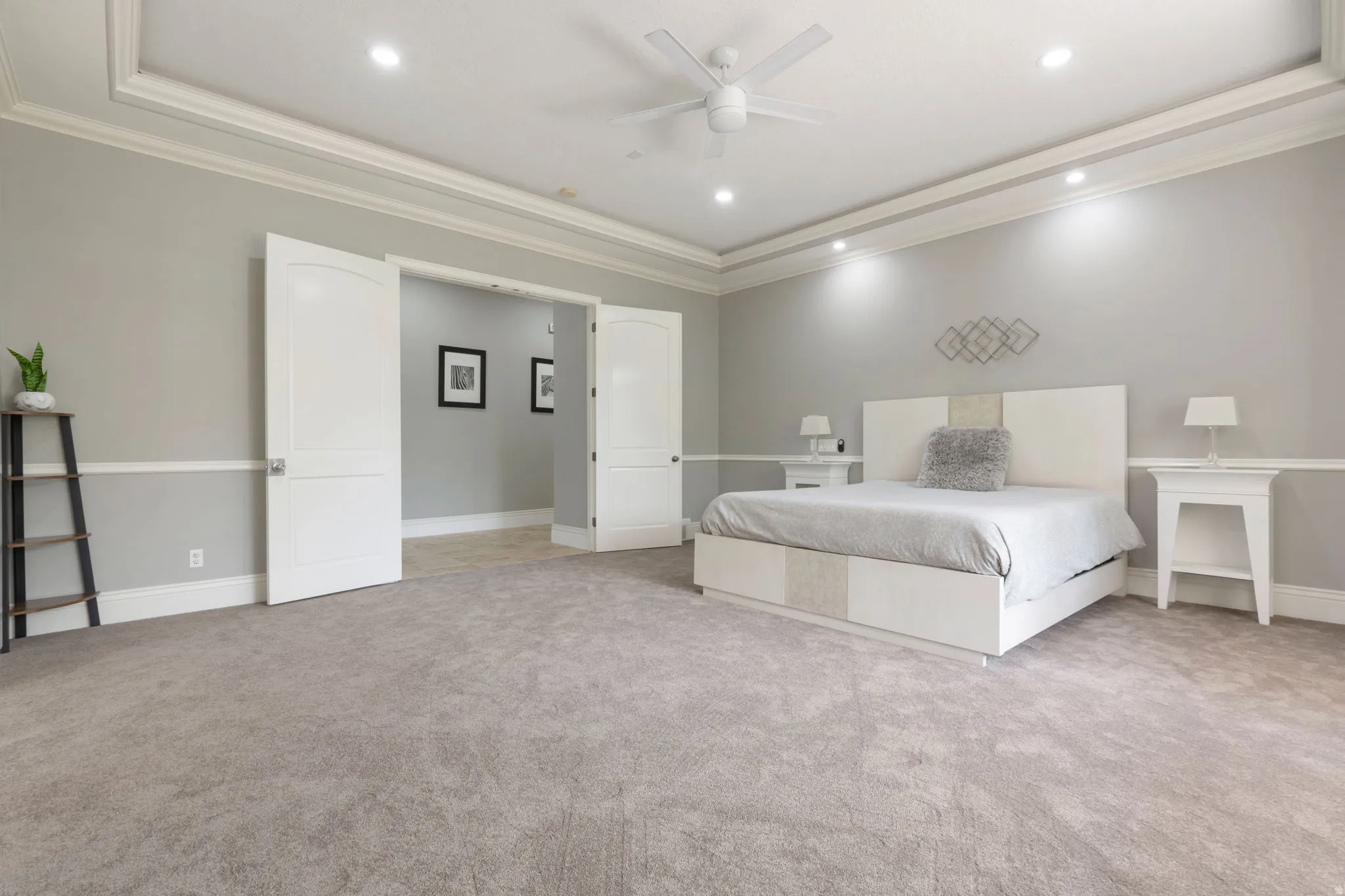 Recessed lighting, ceiling fan, crown molding, double doors, and carpet flooring