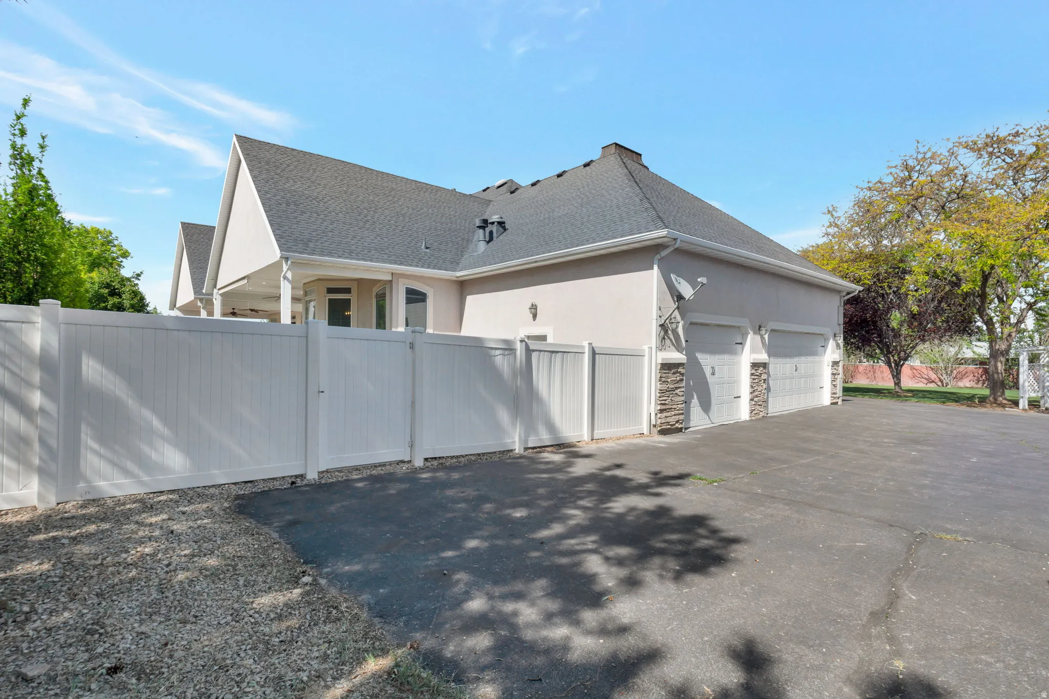 Three-car garage with stone veneer accents