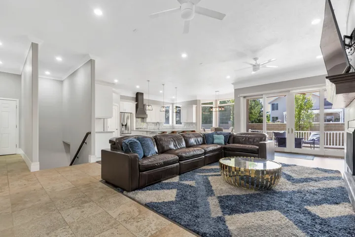 Recessed lighting throughout, two ceiling fans, tile flooring, and sliding glass doors to outdoor area