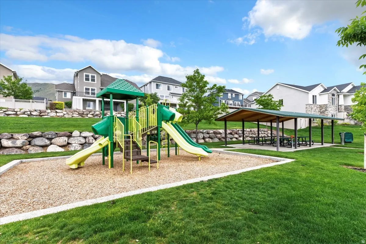 Community playground with a multi-level structure and slides on a wood chip base