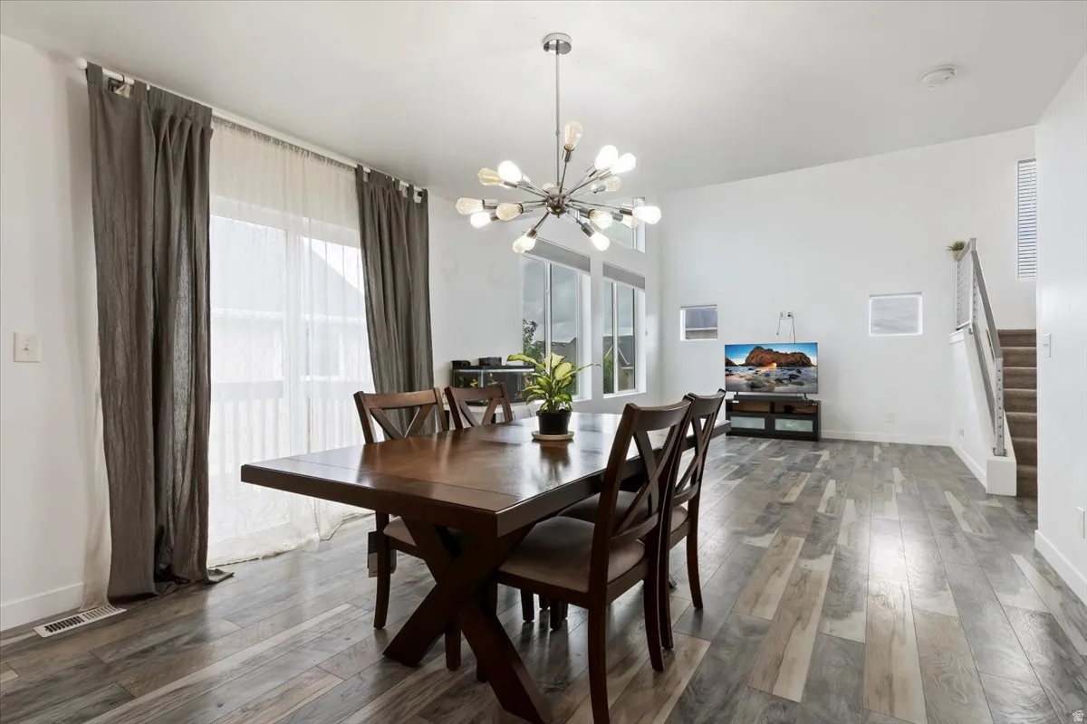 Vaulted ceilings, wood-finish flooring, and a modern sputnik chandelier