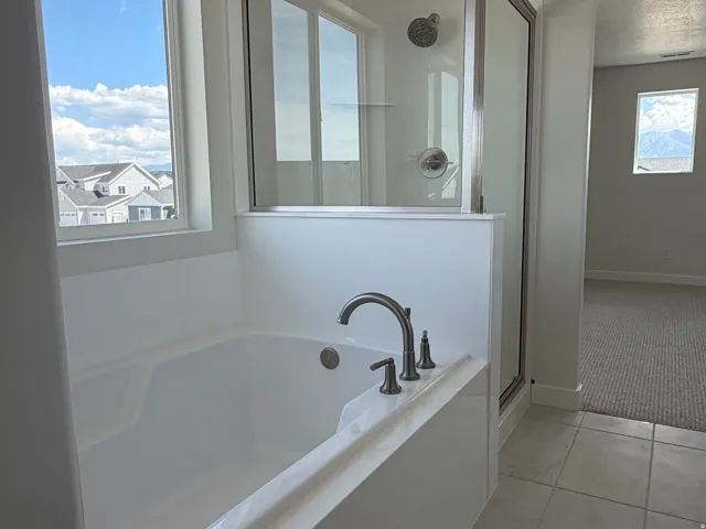 Retreat in this deep soaker tub, bring the bath bomb and refresh. Or, hop in the shower so you're not late.