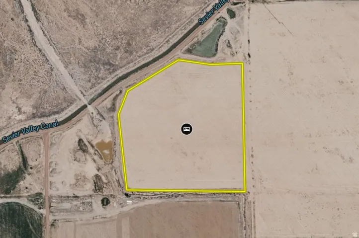 Property Boundary Overlay. An aerial view of the property, delineated by a yellow border, with the Sevier Valley Canal marking its northern boundary