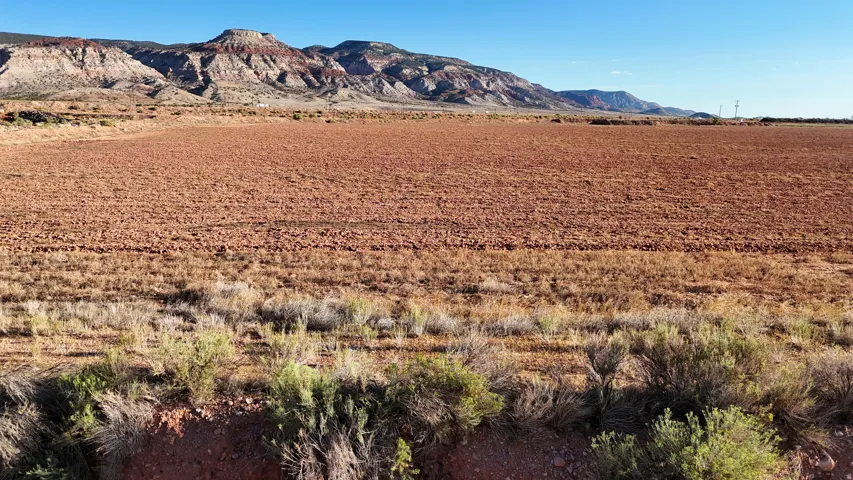 Expansive land parcel featuring cultivated earth and natural desert flora
