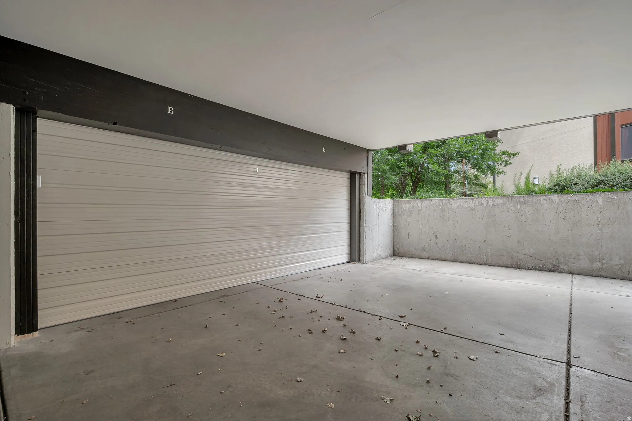 Newly installed garage door with opener and keypad. Storage closet.