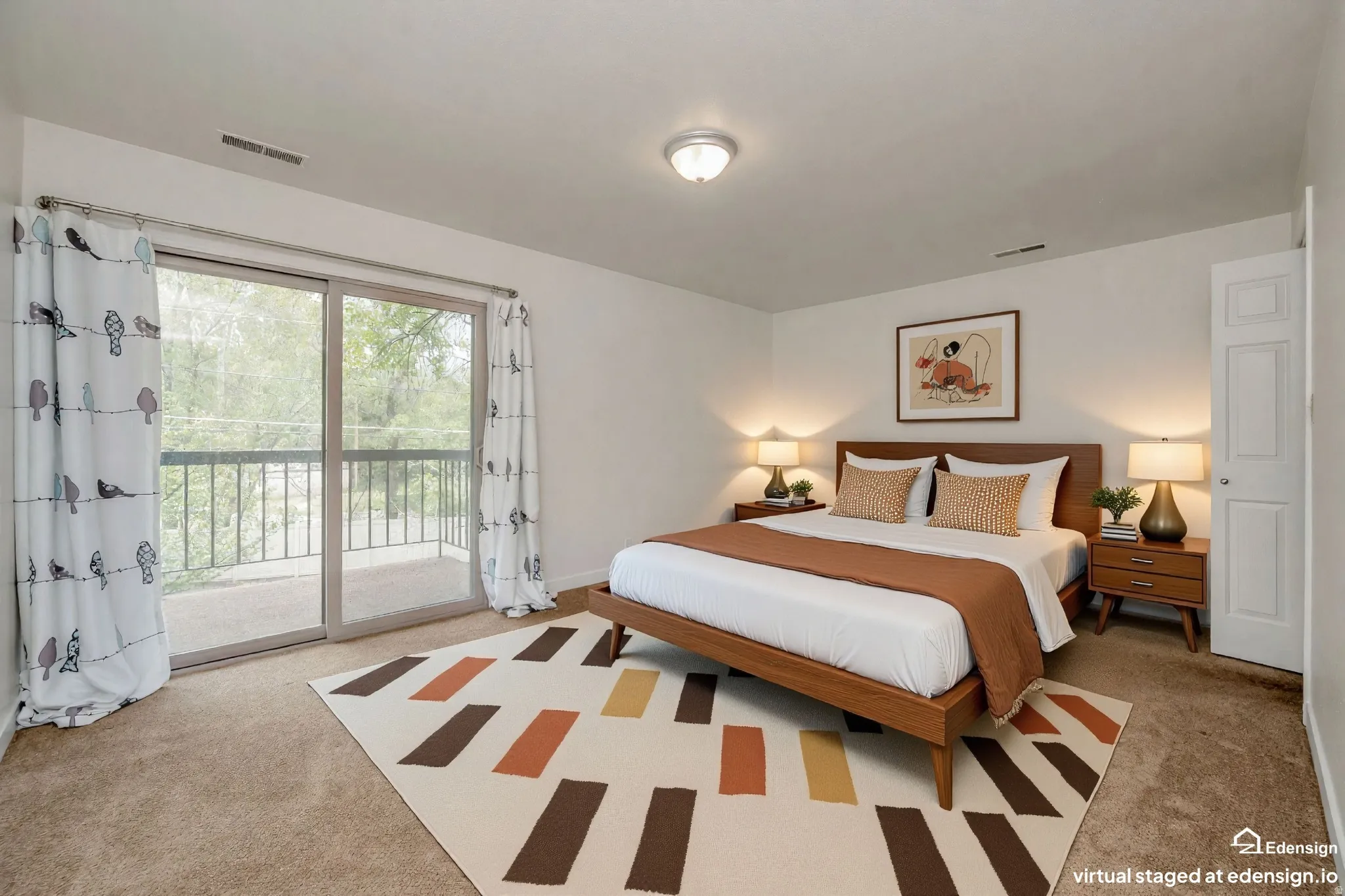 Primary bedroom with ensuite bathroom. Sliding glass doors opening to a private balcony. Walk-in closet.