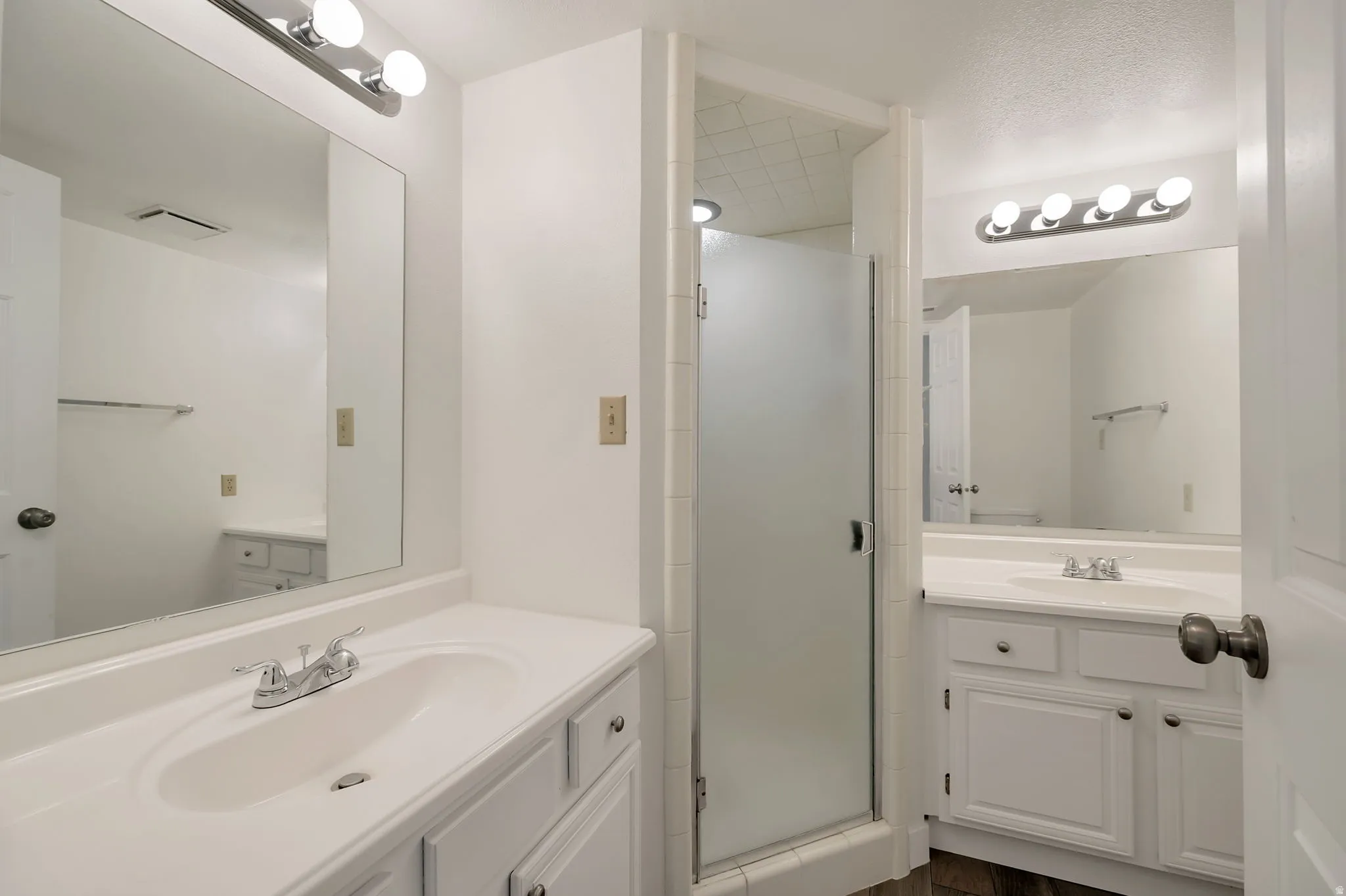 Primary bedroom attached bathroom. Double sinks. Laminate floors.