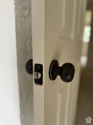 Six-panel interior door featuring an oil-rubbed bronze round knob and matching circular escutcheon