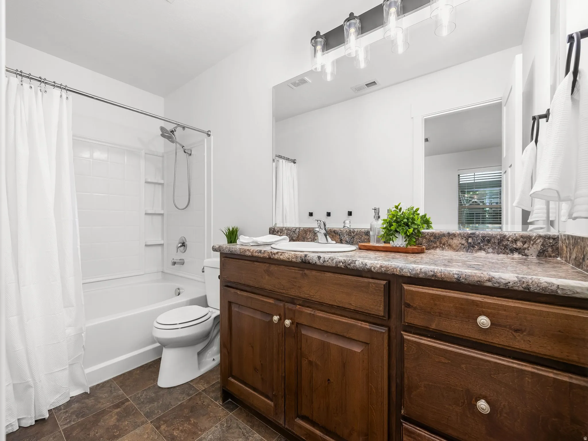 White bathtub and shower combination with white subway tile surround