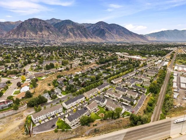 Expansive mountain backdrop with a dense residential area featuring numerous townhome-style properties