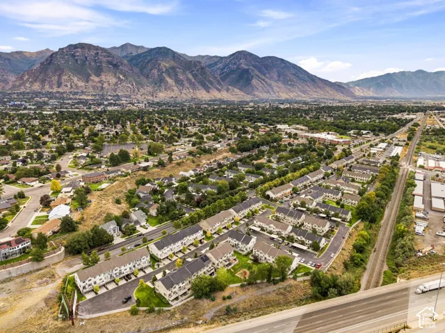 Expansive mountain backdrop with a dense residential area featuring numerous townhome-style properties