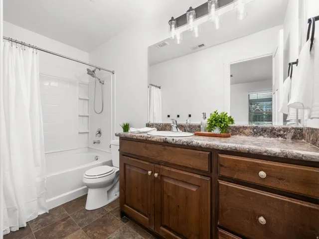 White bathtub and shower combination with white subway tile surround