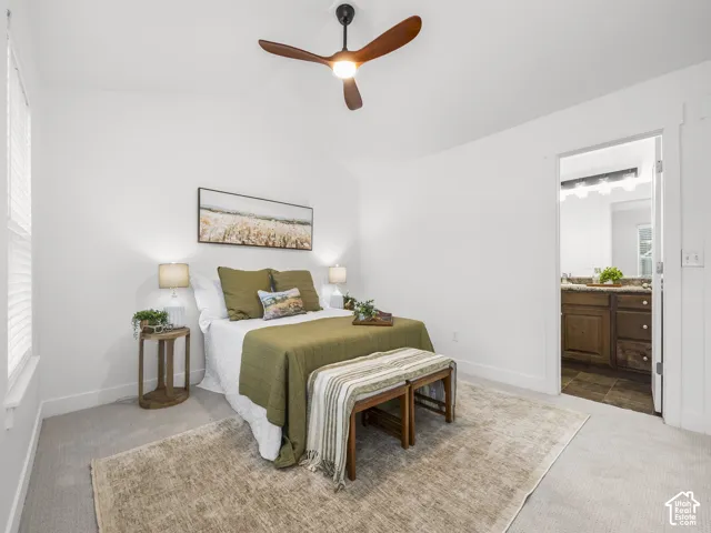 Vaulted ceilings with a ceiling fan, carpet flooring, and a window with blinds