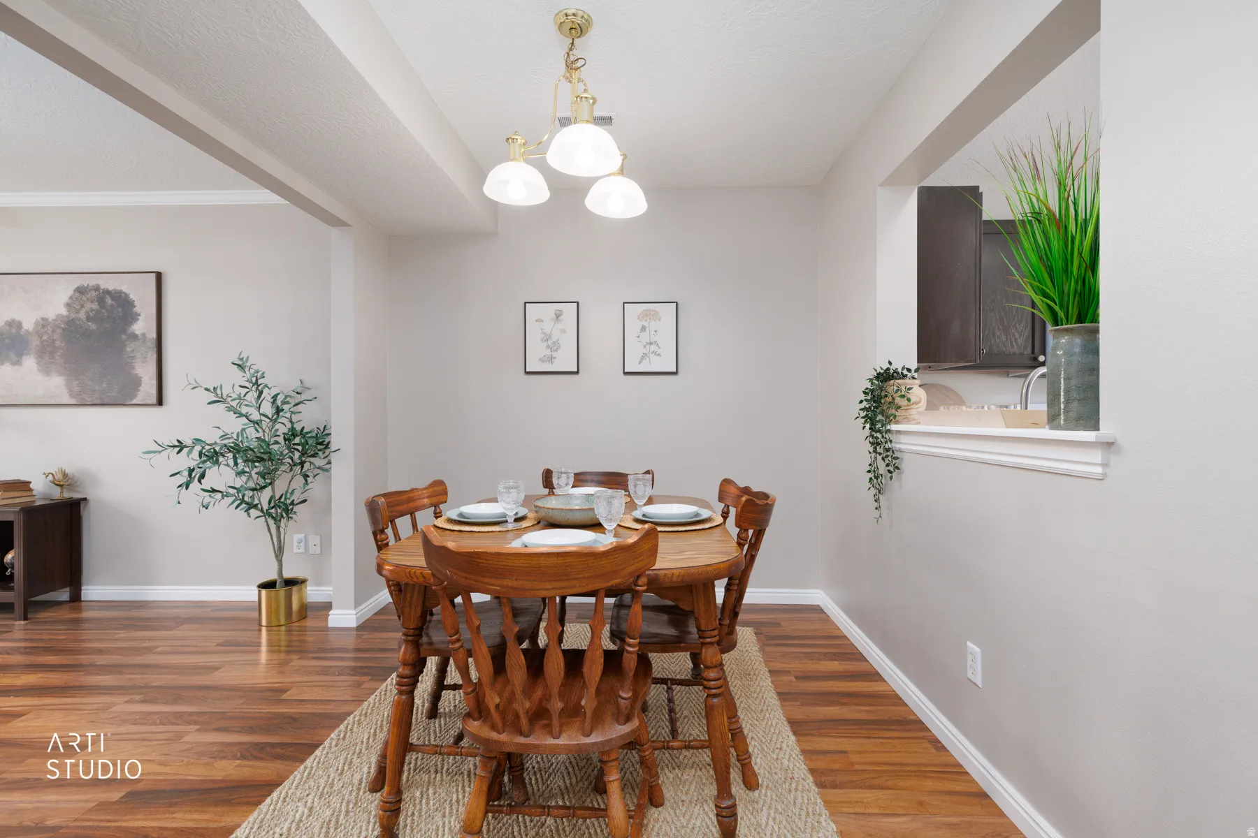Dining area with vinyl flooring, overhead lighting, and a pass-through window with a decorative ledge