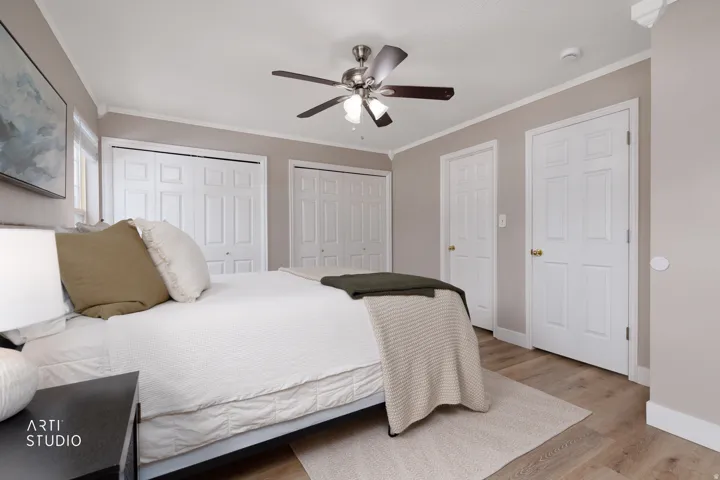 Recessed lighting, LVP flooring, ceiling fan, and white paneled doors