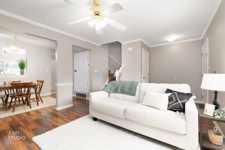 Vinyl flooring, crown molding, ceiling fan with integrated lighting, recessed lighting, and a white interior door