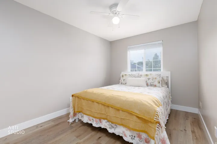 LVP flooring, white trim, single window, and ceiling fan with integrated lighting