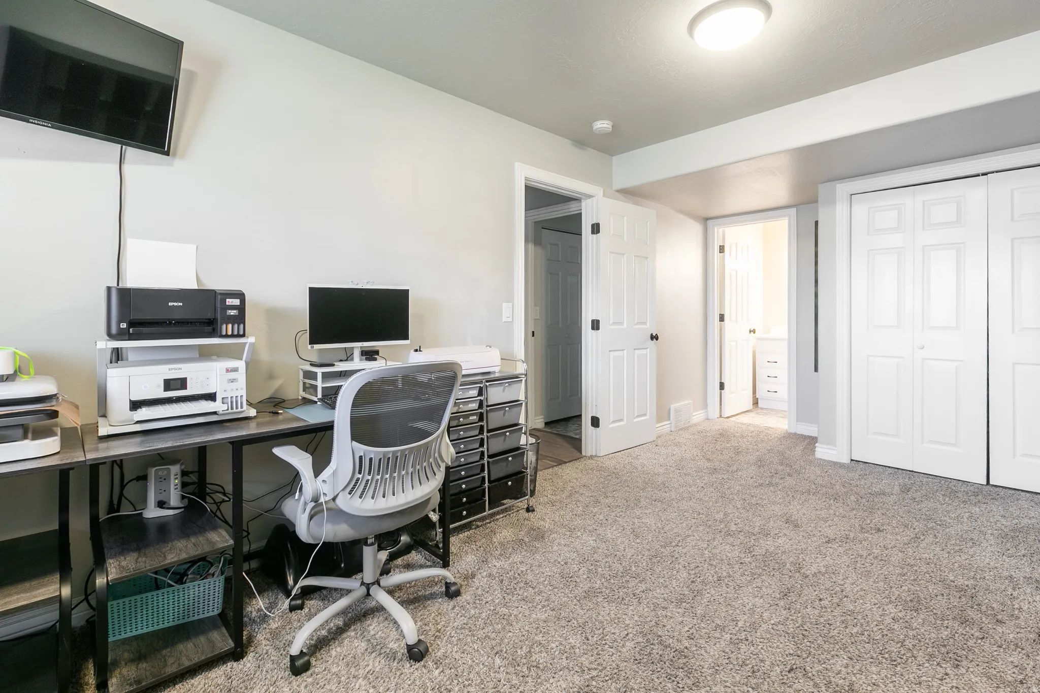Soft gray carpeting, light gray wall paint, and white trim accents