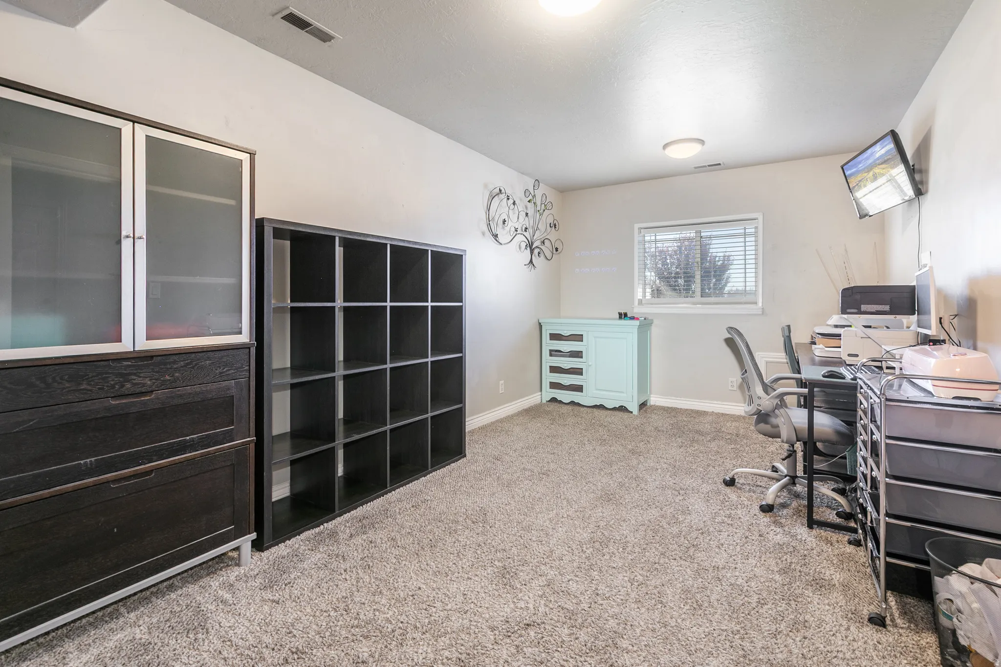 Carpeted room with a window, recessed lighting, and a neutral wall color