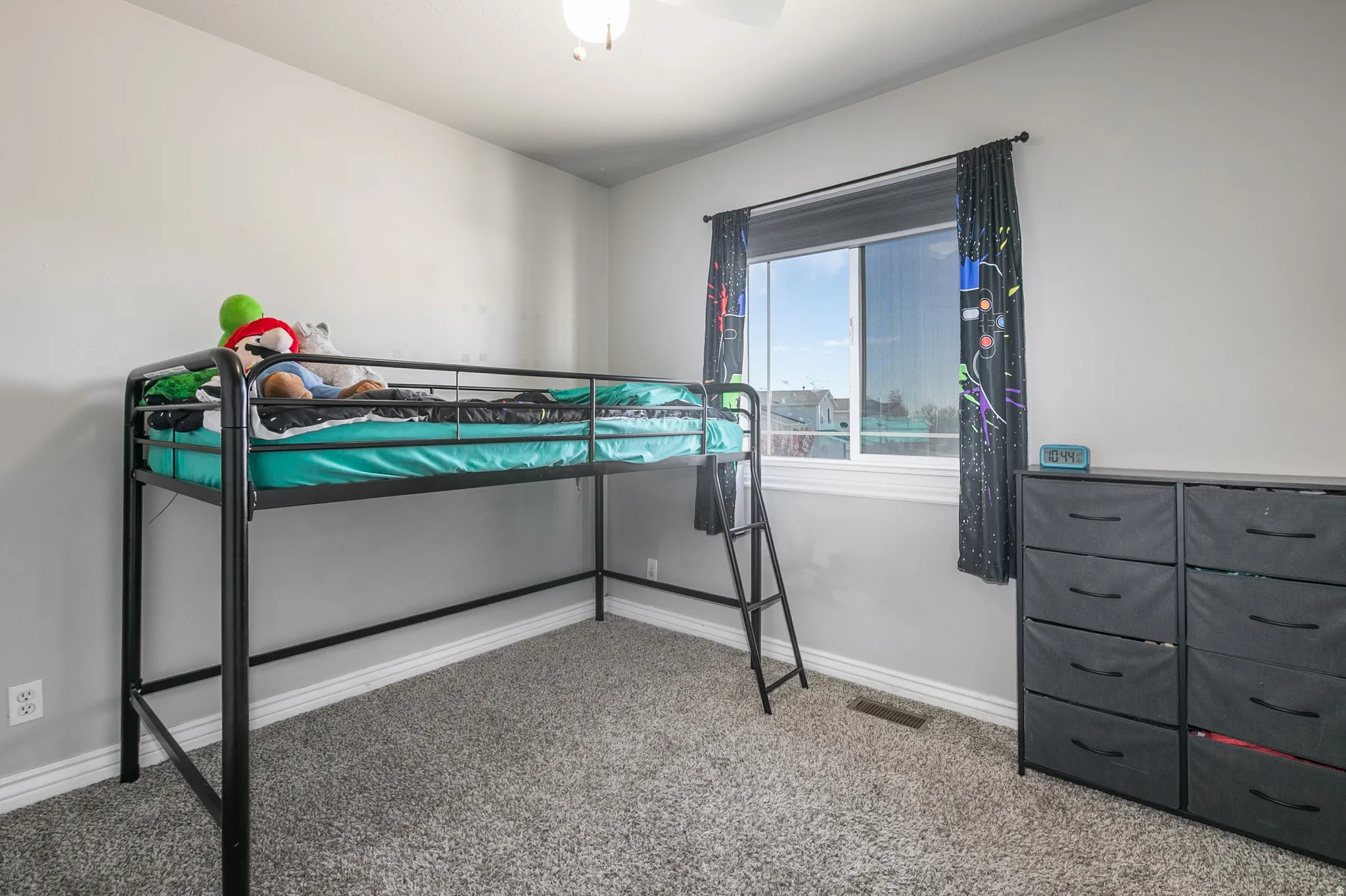 Carpeted flooring, white trim, and a ceiling-mounted light fixture